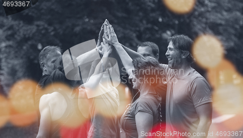 Image of runners giving high five to each other