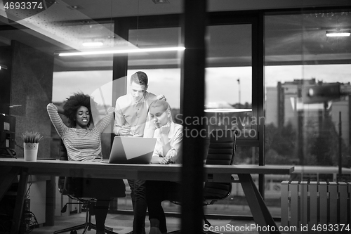 Image of Multiethnic startup business team in night office