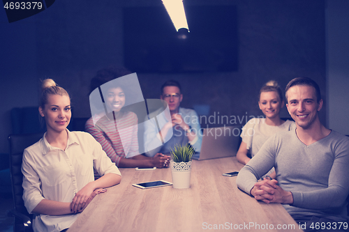 Image of Multiethnic startup business team in night office