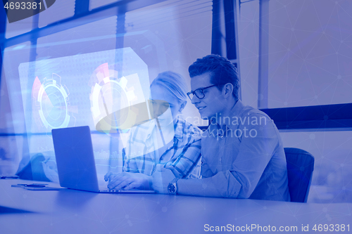 Image of Two Business People Working With laptop in office