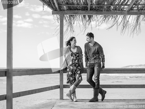 Image of Couple chating and having fun at beach bar