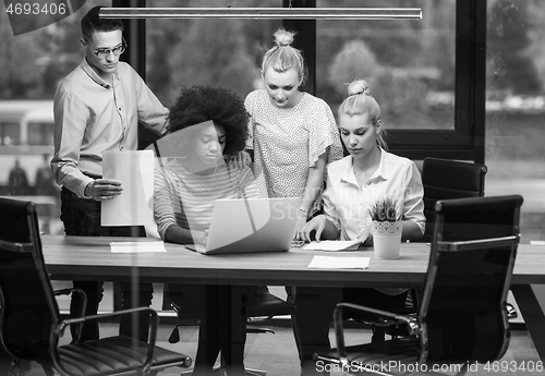 Image of Multiethnic startup business team in night office