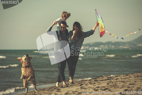Image of happy young family enjoying vecation during autumn day