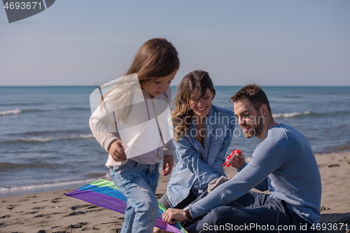 Image of happy family enjoying vecation during autumn day