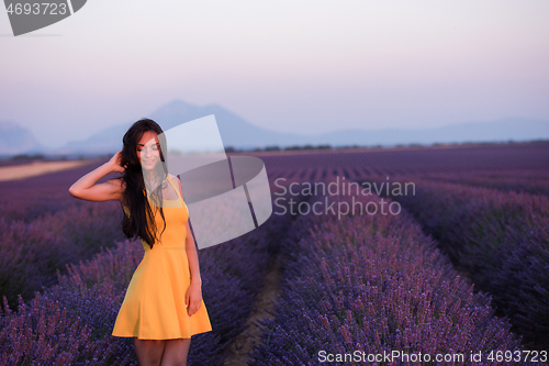 Image of woman in yellow dress at lavender field