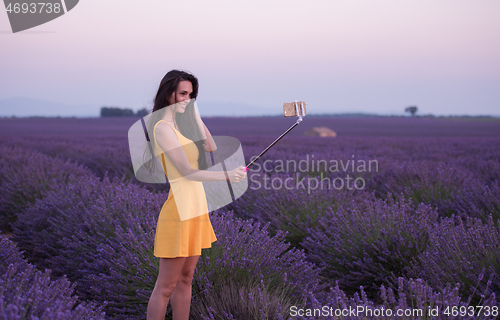 Image of woman in lavender field taking selfie