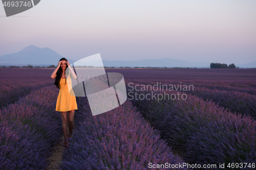 Image of woman in yellow dress at lavender field