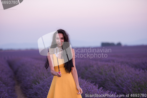 Image of woman in lavender field taking selfie