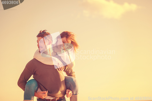 Image of couple having fun at beach during autumn