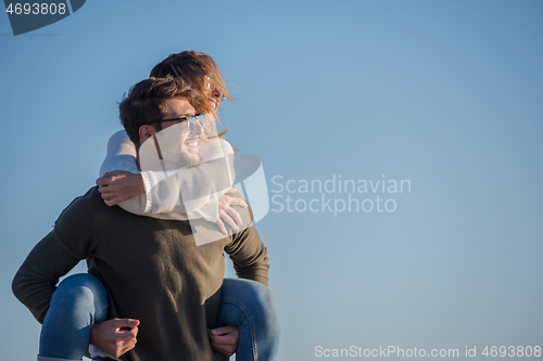 Image of couple having fun at beach during autumn