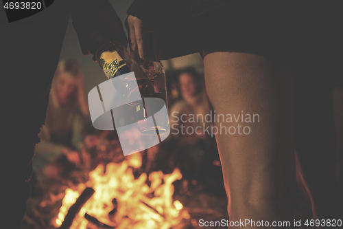 Image of Friends having fun at beach on autumn day