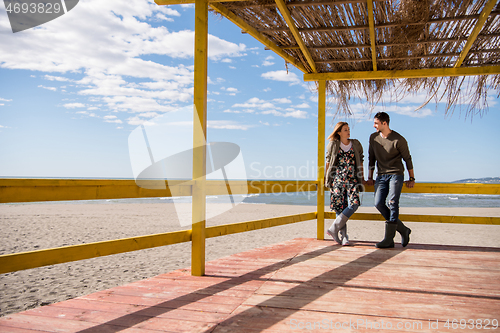 Image of Couple chating and having fun at beach bar