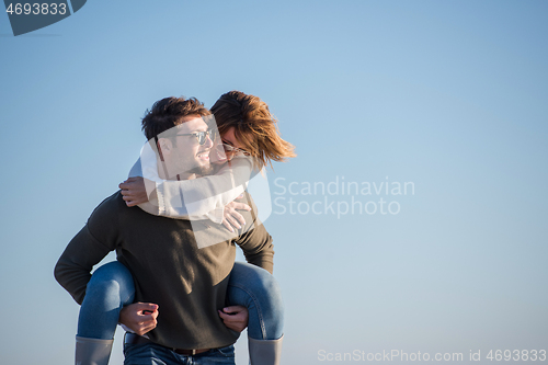 Image of couple having fun at beach during autumn