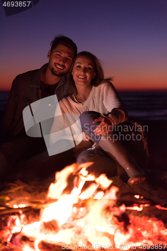 Image of portrait of young Couple enjoying  at night on the beach