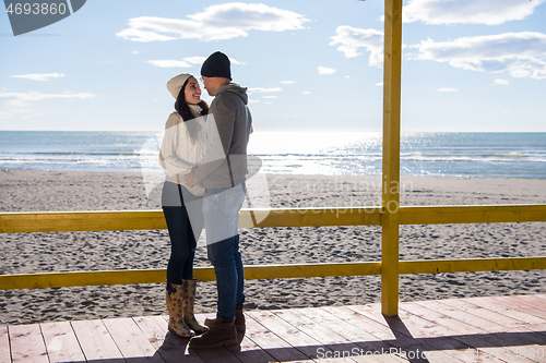 Image of Couple chating and having fun at beach bar