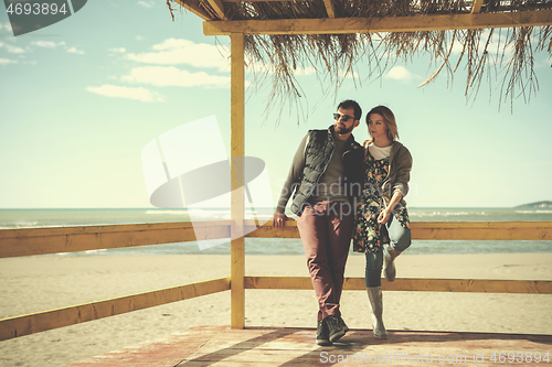 Image of Couple chating and having fun at beach bar