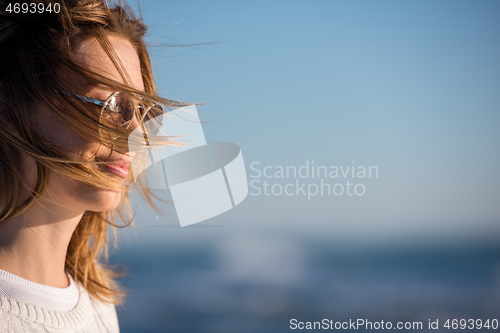 Image of Young woman enjoying the warm autumn day