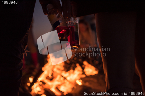 Image of Friends having fun at beach on autumn day