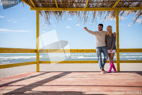 Image of Couple chating and having fun at beach bar