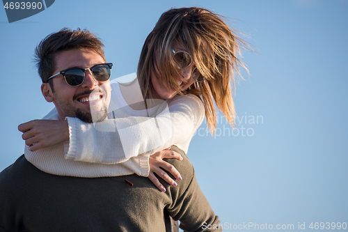 Image of couple having fun at beach during autumn