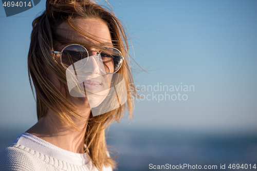 Image of Young woman enjoying the warm autumn day