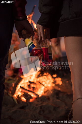 Image of Friends having fun at beach on autumn day