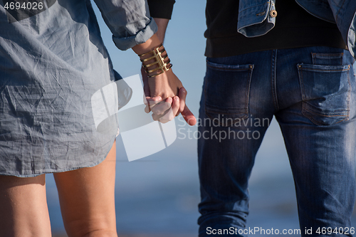 Image of Loving young couple on a beach at autumn sunny day