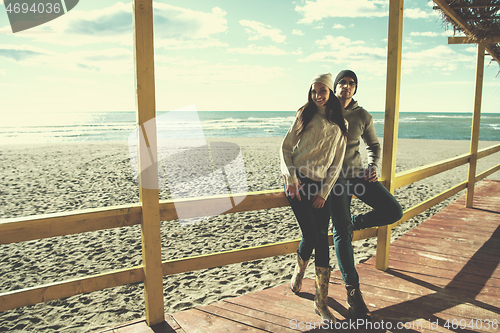 Image of Couple chating and having fun at beach bar