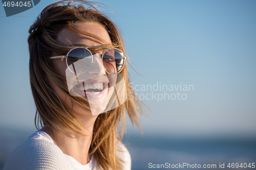 Image of Young woman enjoying the warm autumn day