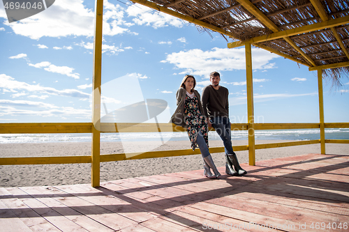 Image of Couple chating and having fun at beach bar