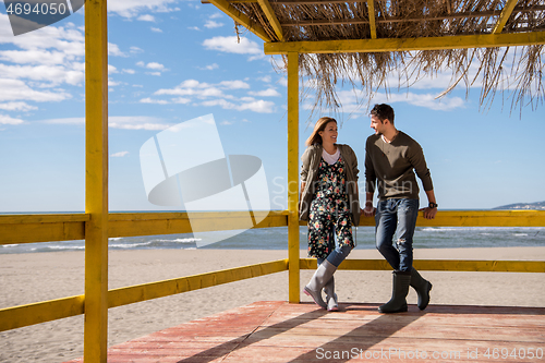 Image of Couple chating and having fun at beach bar