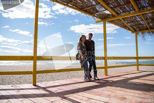 Image of Couple chating and having fun at beach bar