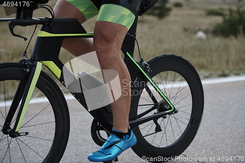 Image of closeup of triathlon athlete riding bike