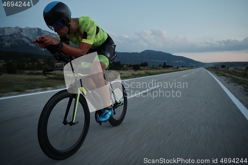 Image of triathlon athlete riding bike at night