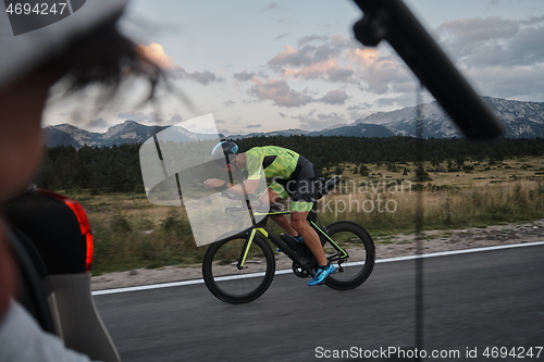 Image of cinematographer taking action shot of triathlon bike athlete