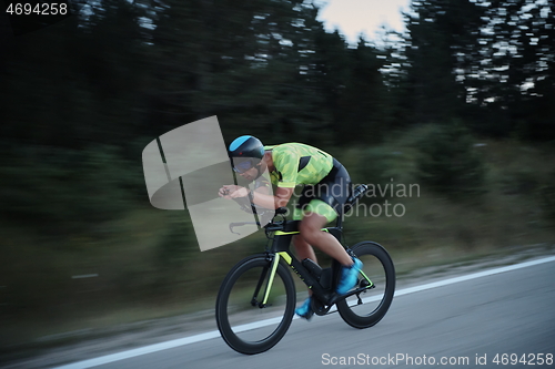 Image of triathlon athlete riding bike at night