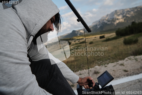 Image of cinematographer taking action shot of triathlon bike athlete