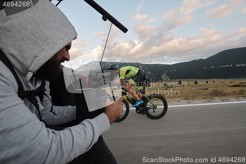 Image of cinematographer taking action shot of triathlon bike athlete