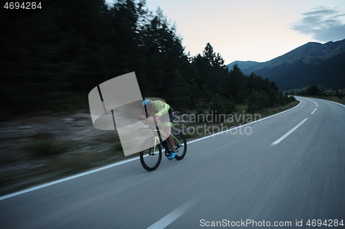 Image of triathlon athlete riding bike at night