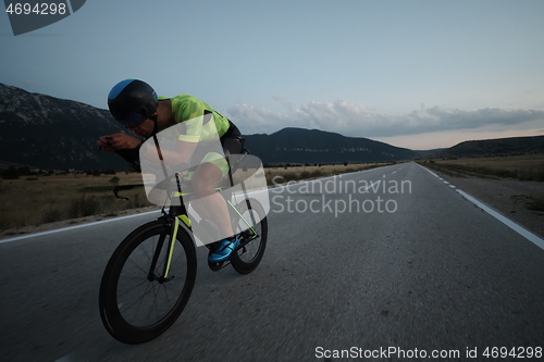 Image of triathlon athlete riding bike at night