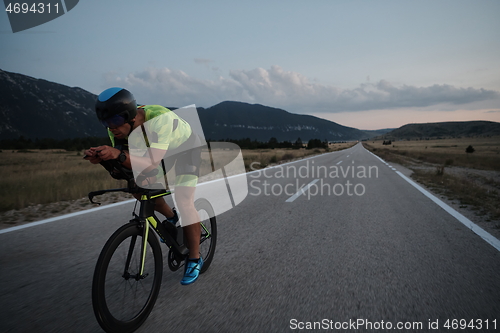 Image of triathlon athlete riding bike at night