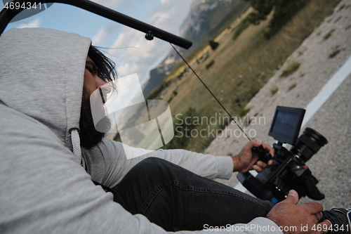 Image of cinematographer taking action shot of triathlon bike athlete