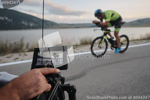 Image of cinematographer taking action shot of triathlon bike athlete