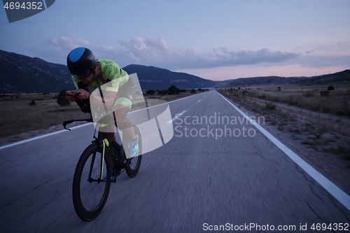 Image of triathlon athlete riding bike at night