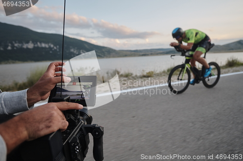 Image of cinematographer taking action shot of triathlon bike athlete