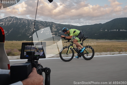 Image of cinematographer taking action shot of triathlon bike athlete