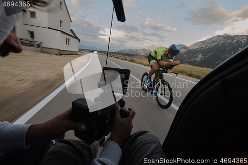 Image of cinematographer taking action shot of triathlon bike athlete