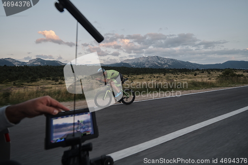 Image of cinematographer taking action shot of triathlon bike athlete