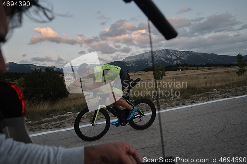 Image of cinematographer taking action shot of triathlon bike athlete