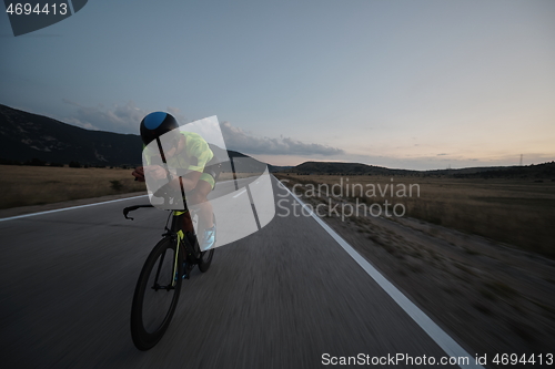 Image of triathlon athlete riding bike at night